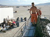 On Bus Making Bus Tent Out of Camo Netting.jpg