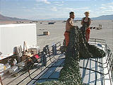 On Bus Making Bus Tent Out of Camo Netting.jpg