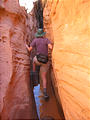 Little Wild Horse Canyon Hike - Laura Climbing over Puddle (1:04 PM Oct 7, 2005)